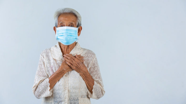 Grandmother is puting her hands in the lock and hoped for the best.- cencept  mask campaign